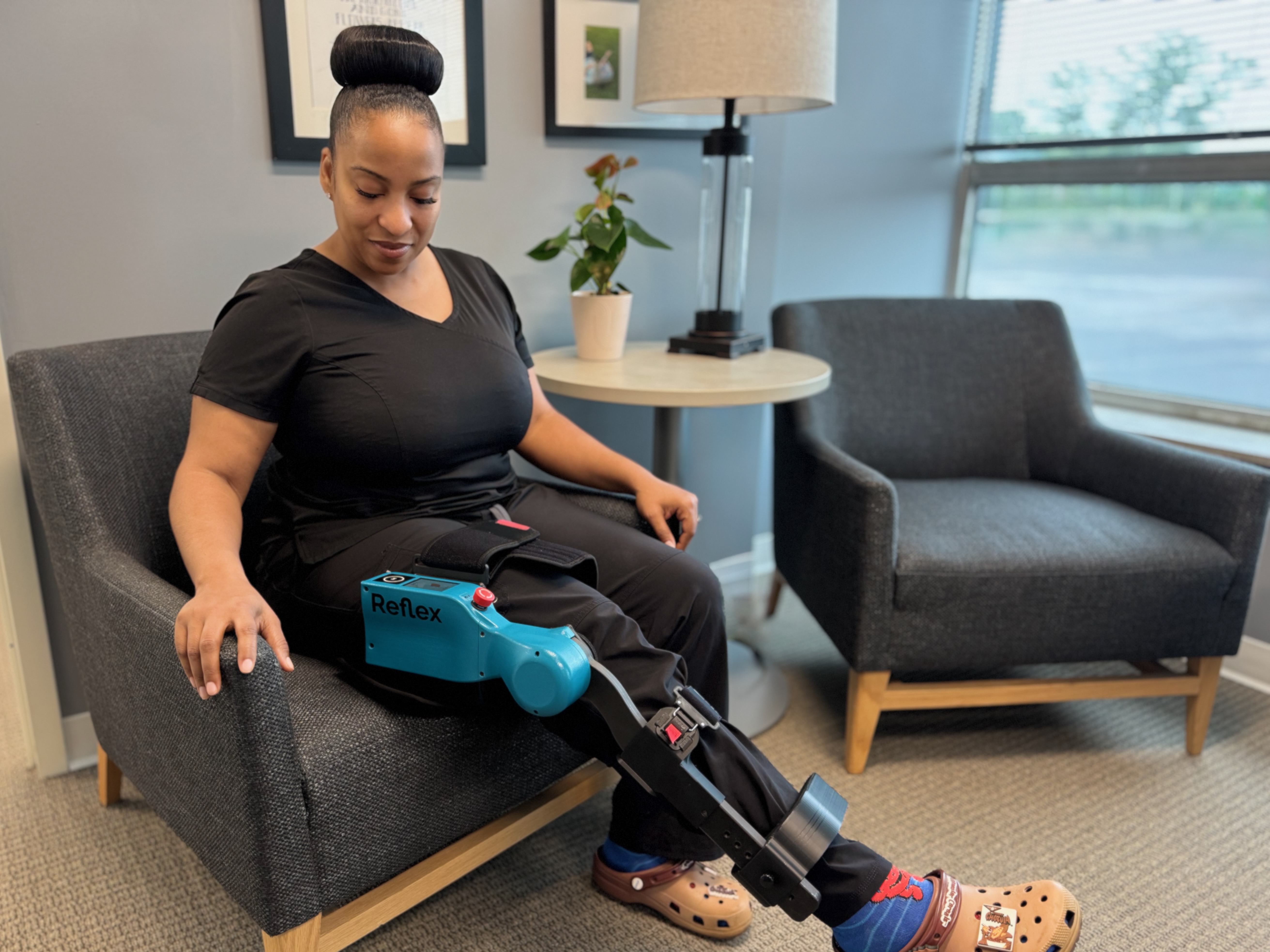 Woman using Reflex Robotic Rehabilitation Device for rehabilitation